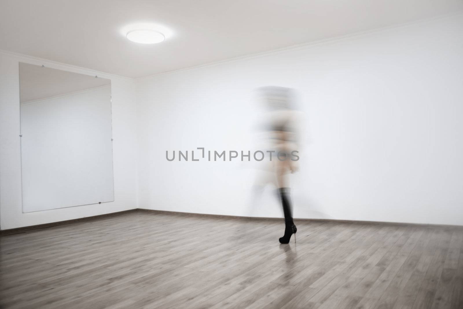 Motion blur of the woman performing dance in ball room