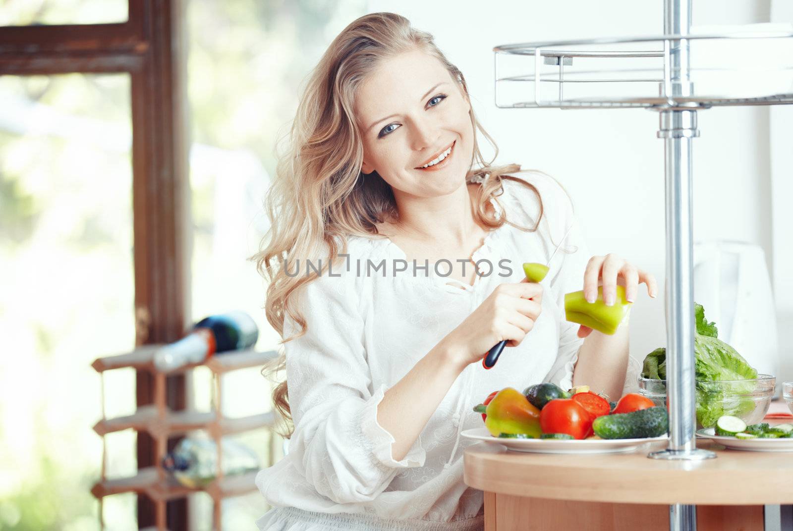 Blond lady at kitchen preparing vegetable for breakfast