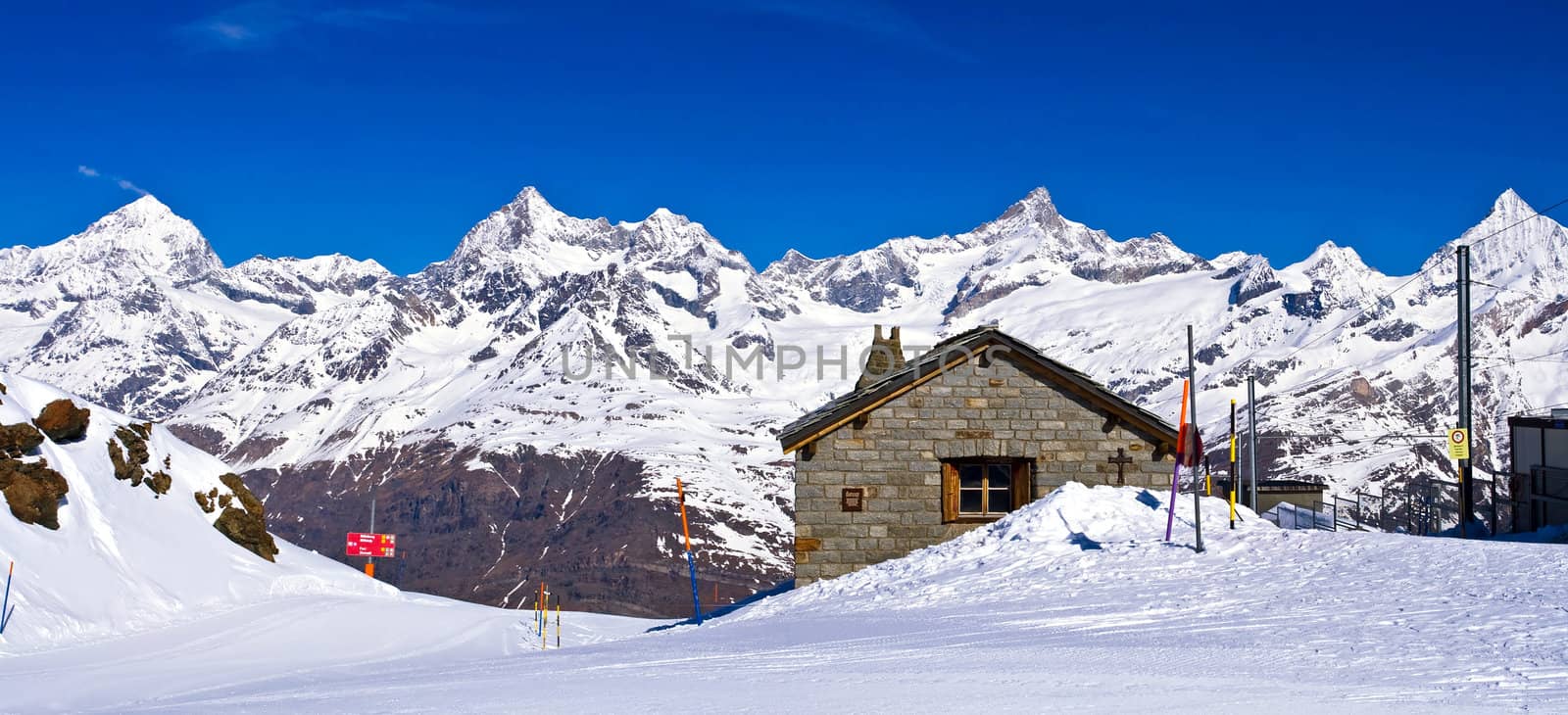 Panoramic view of Swiss alps with Train Station located at Gorne by vichie81
