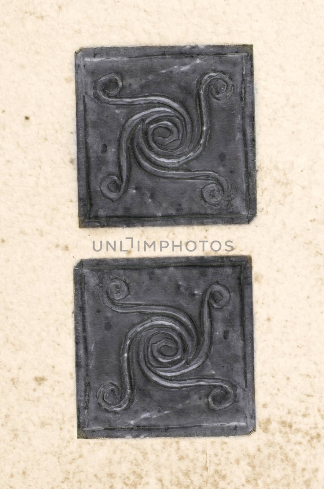 metal spiral motivs on recycled paper texture closeup background.