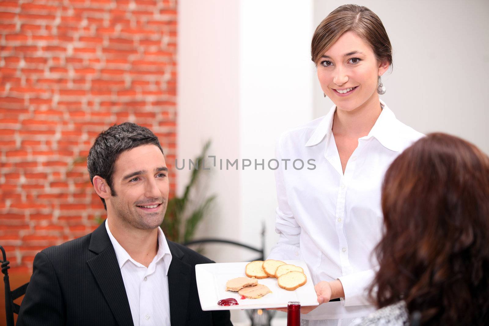 Business lunch in a restaurant by phovoir