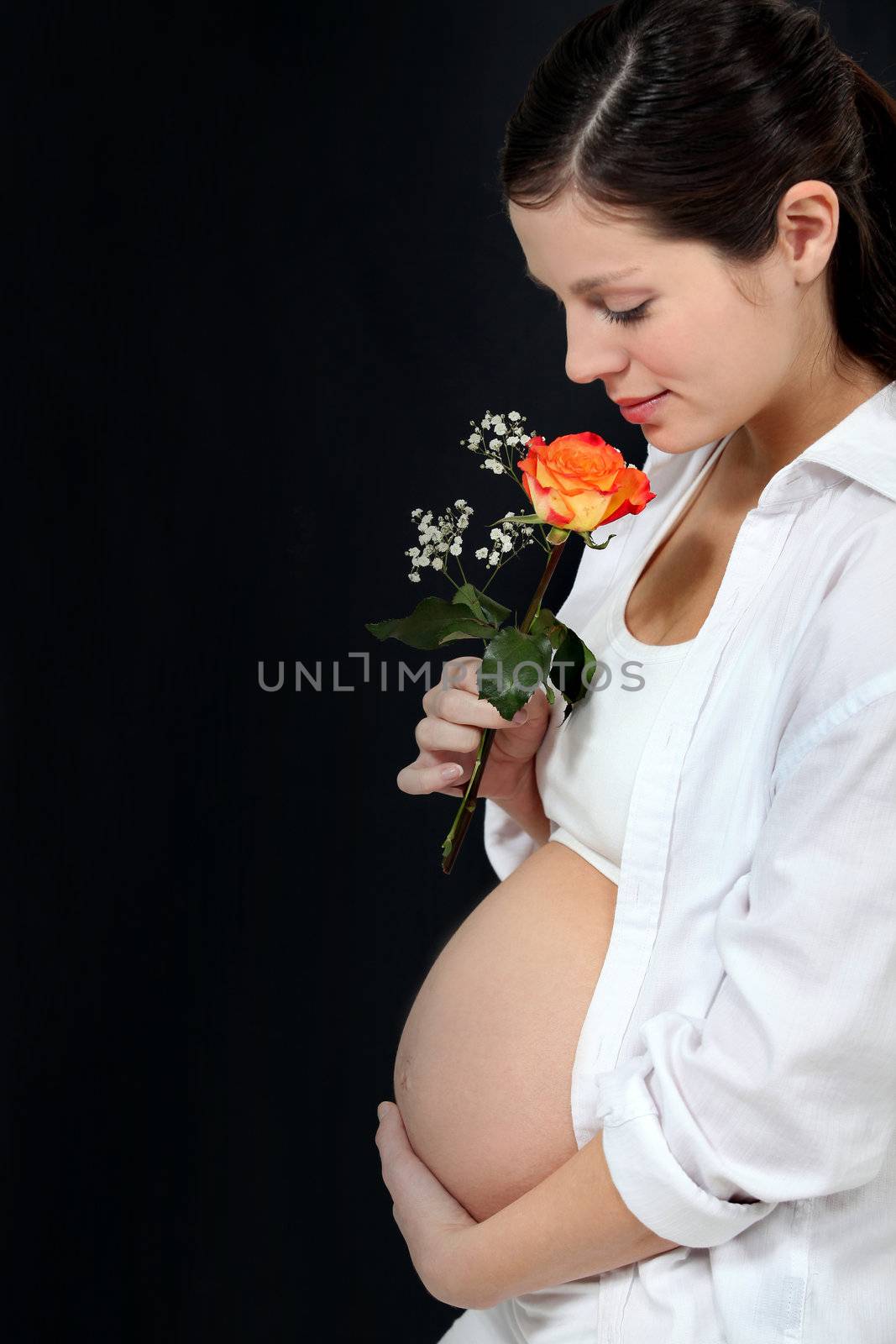 Pregnant woman with a rose