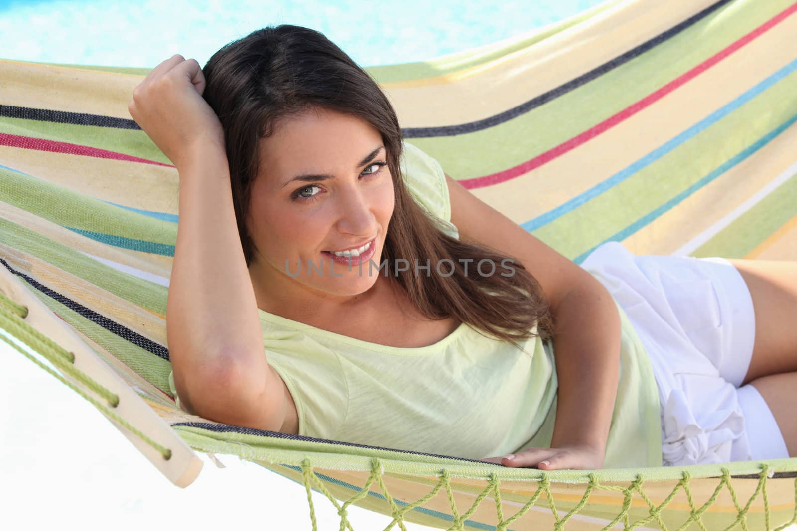 Young brown-haired woman laid in hammock