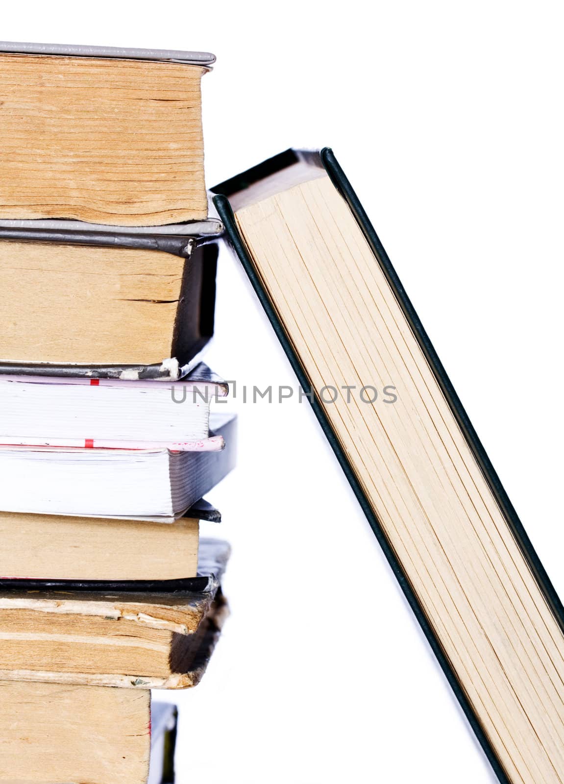 Pile of books and one dedicated isolated on white background