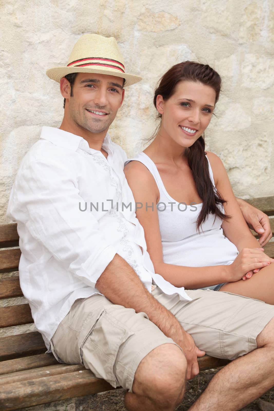 Couple sat on bench by phovoir
