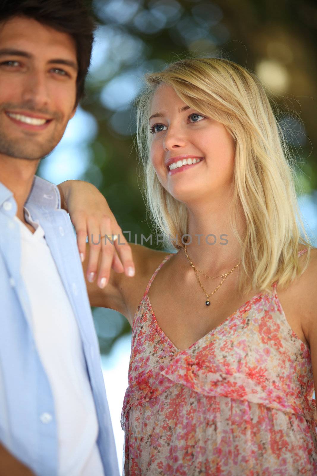 Couple stood in park by phovoir