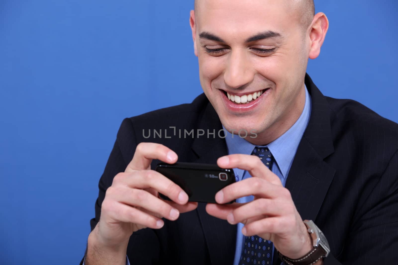 Businessman looking at his camera