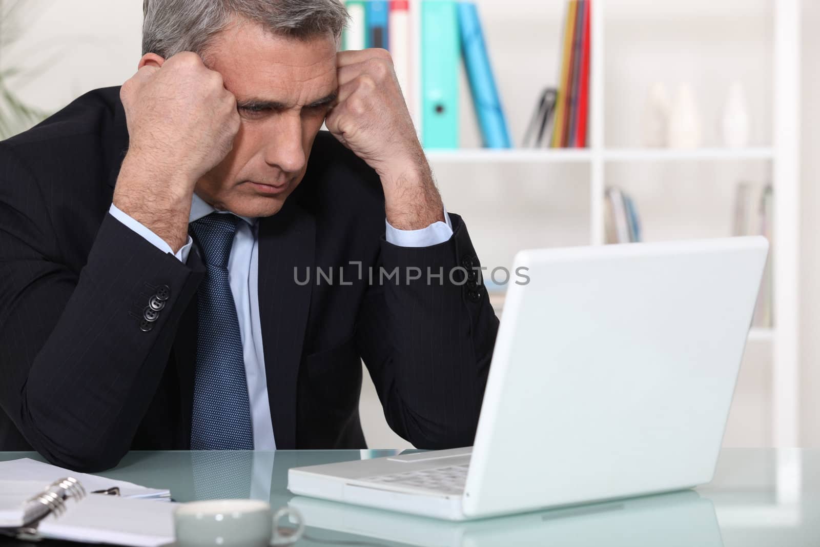 Businessman concentrating on his laptop