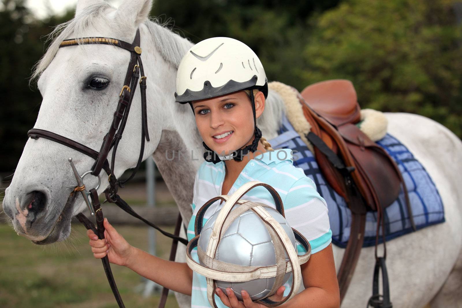 professional female jockey posing with her horse by phovoir