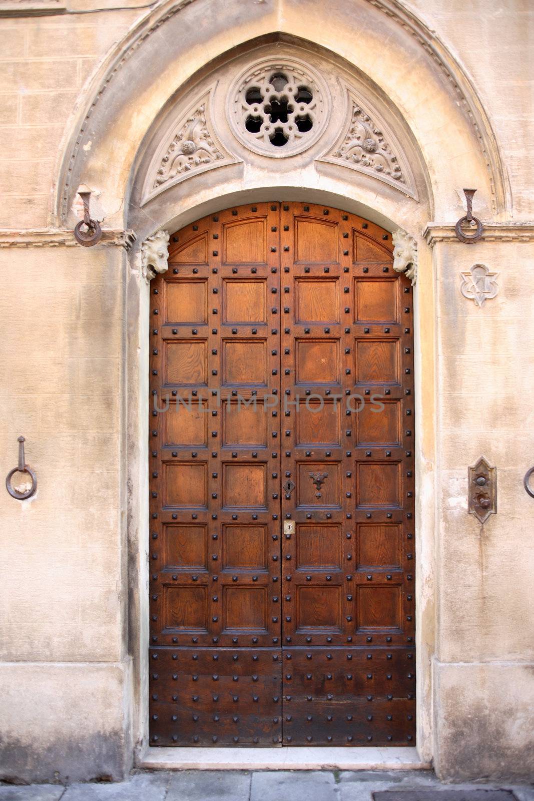 Fragment of old stone building with nice wooden door