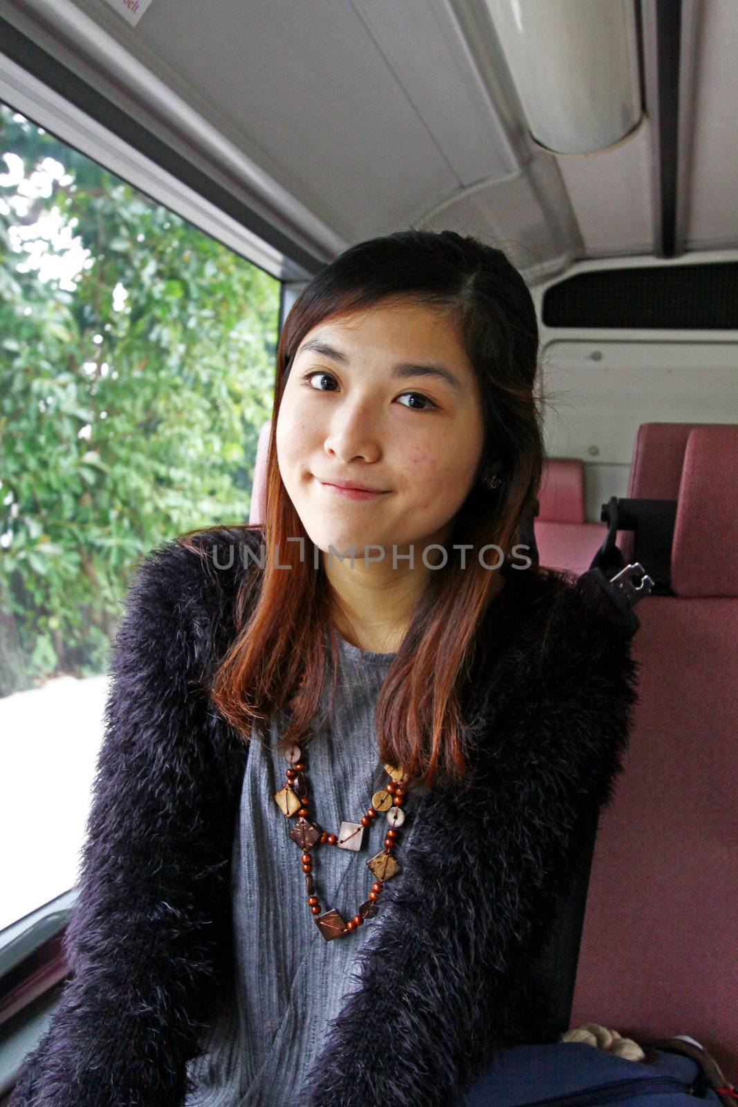 Asian woman in the bus and smiling by kawing921