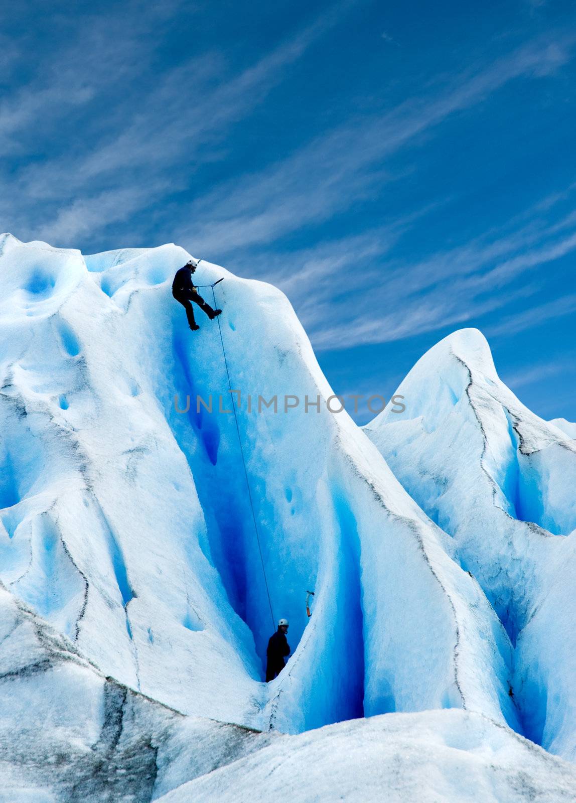 Two men climbing a glacier in patagonia.