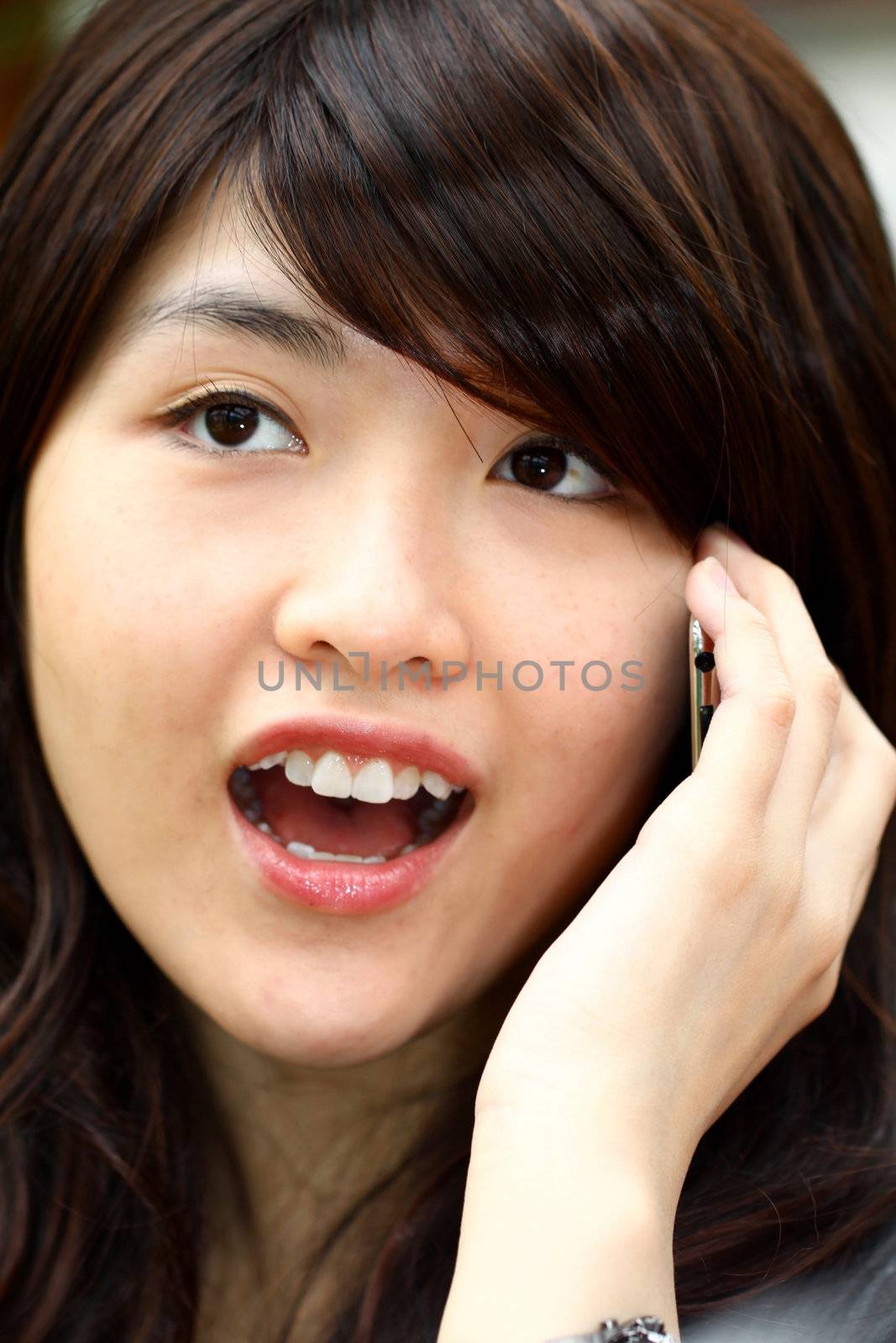Young asian woman talking on phone by kawing921