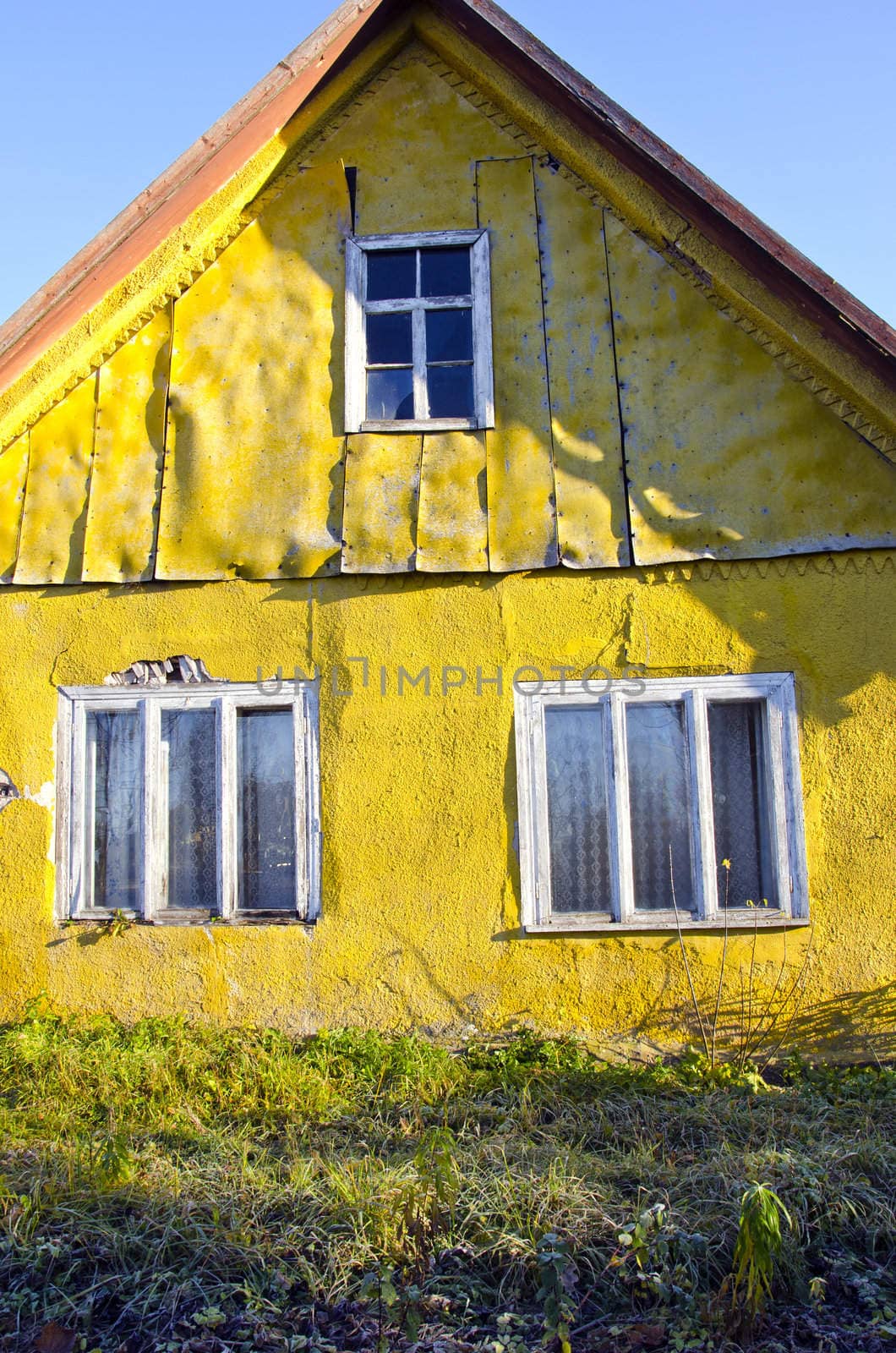 Old rural living homestead yellow wall of house and window.