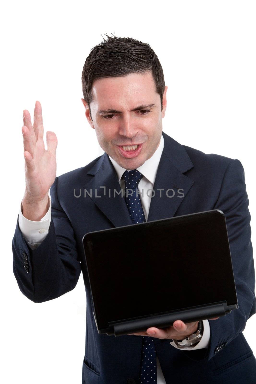 Portrait of frustrated and angry young business man in blue suit with laptop. Isolated on white.