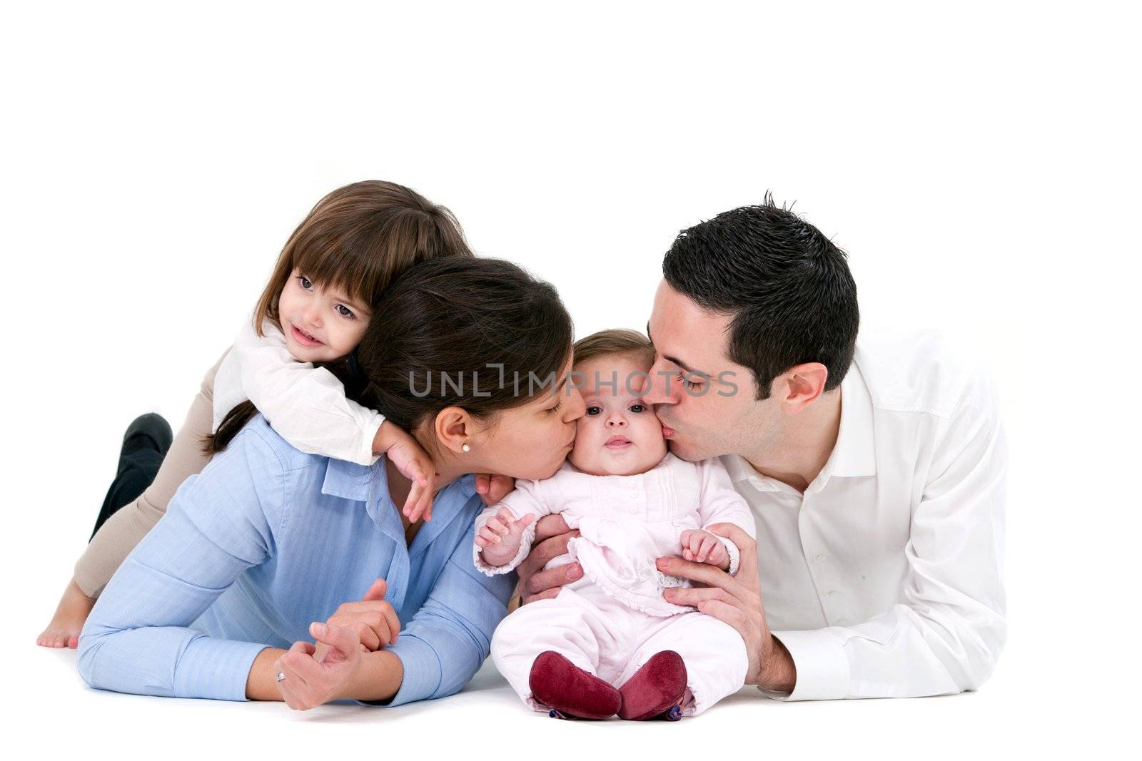 Portrait of young couple and their daughters. Isolated on white background.