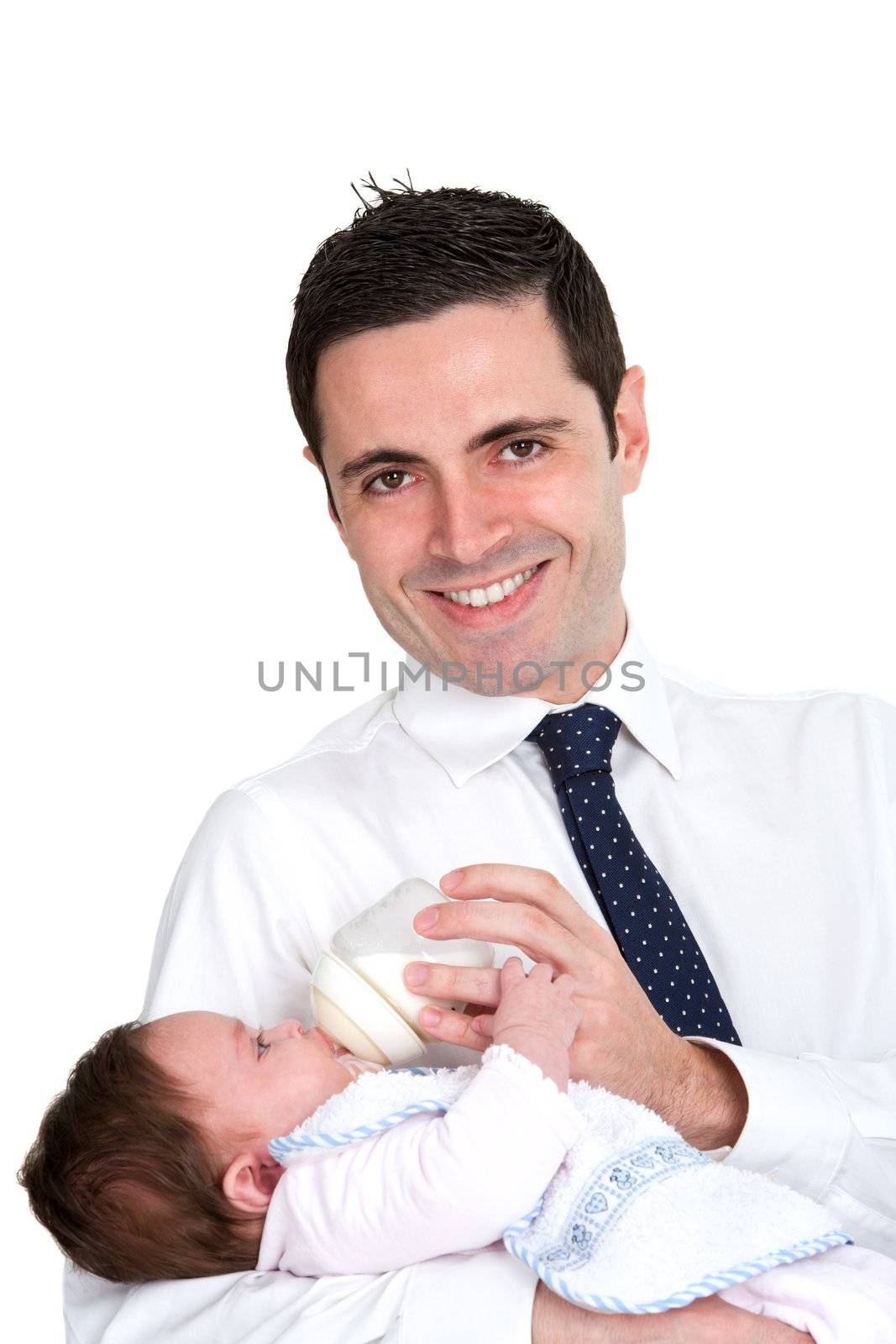 Handsome young business man feeding daughter with milk bottle. Isolated on white.