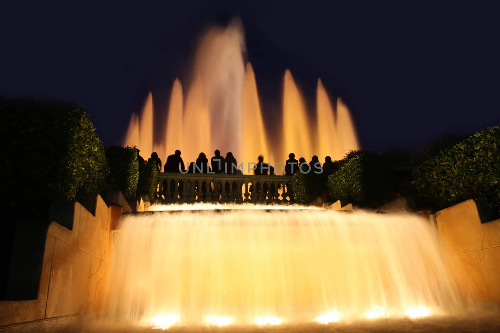 details group tourists photographing fountain in city Barcelona, Spain