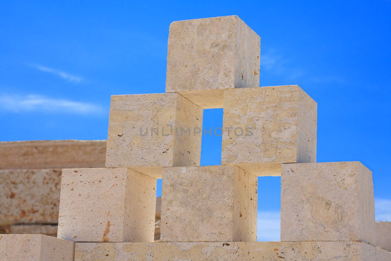 blocks of limestone processed and ready for use, are against the blue sky