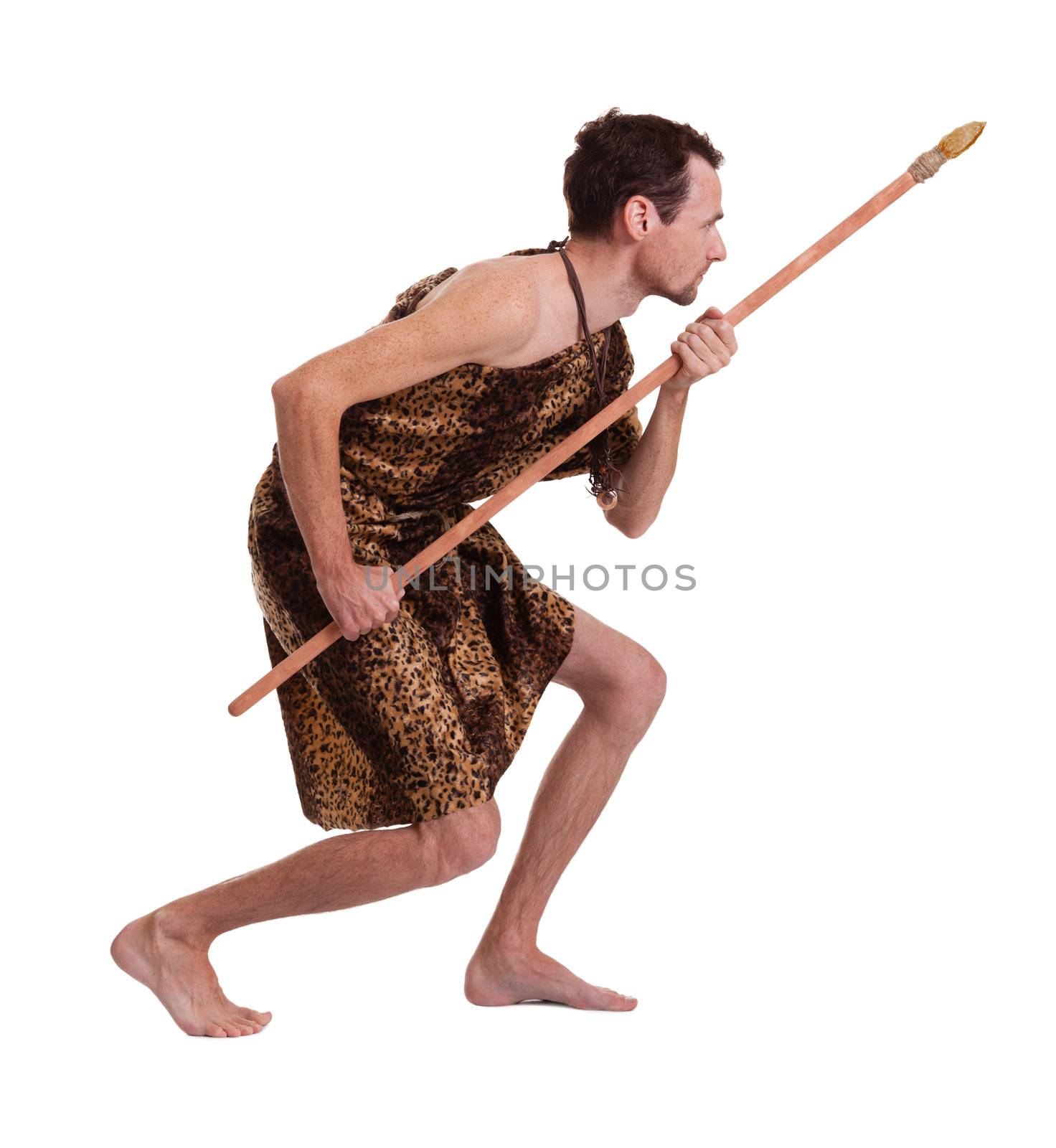 Following man as a savage hunter in skin of a beast with spear isolated on white background