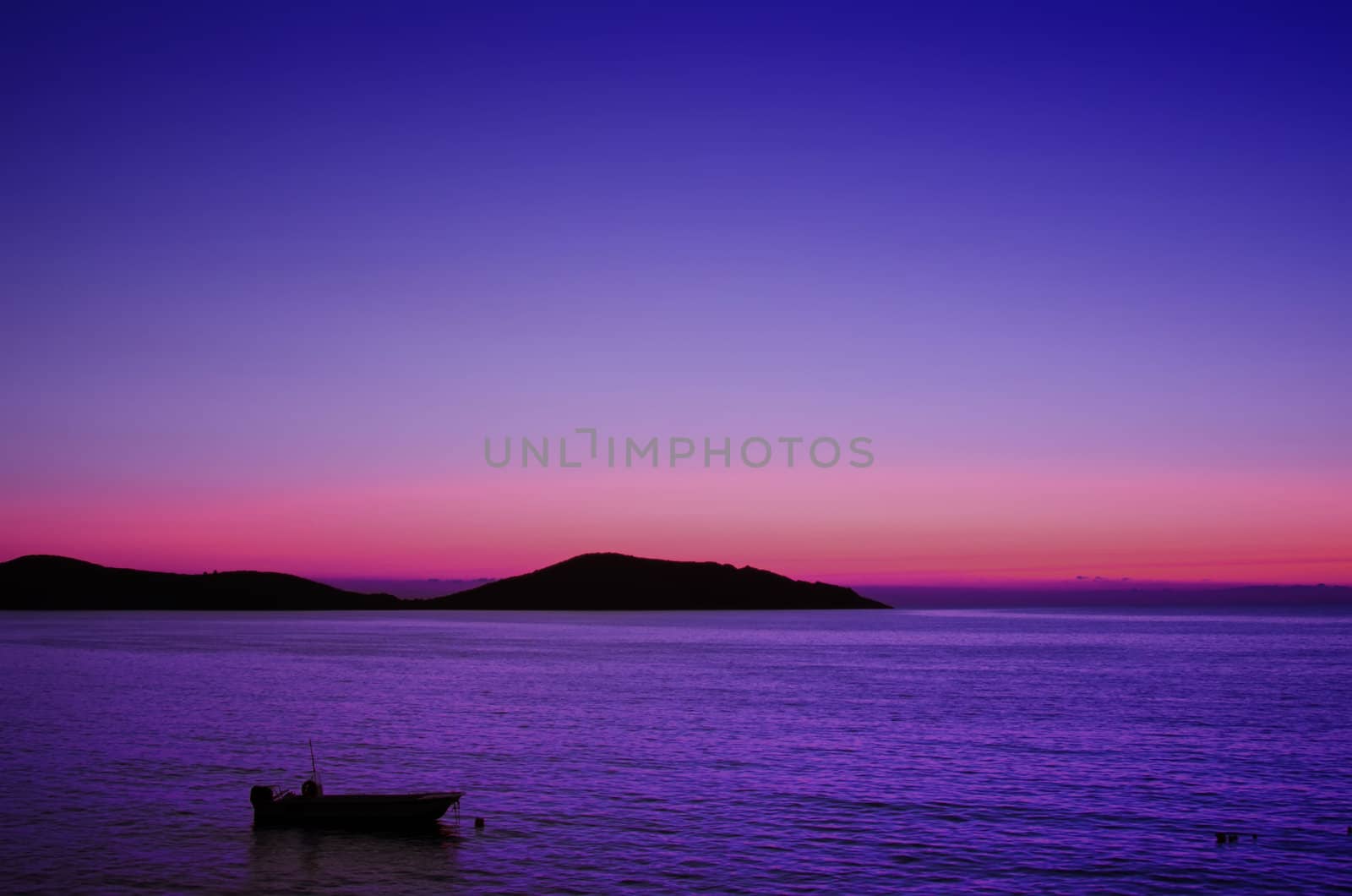 the sea at sunrise and boat