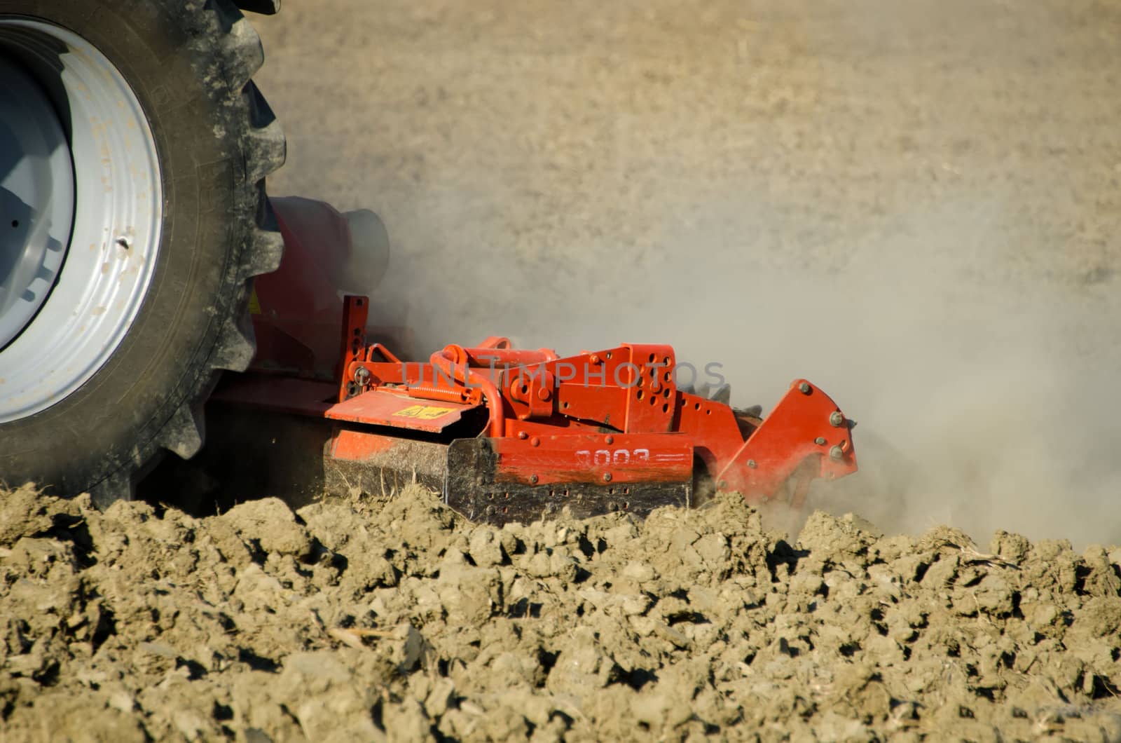 the tractor weeding the fields by njaj