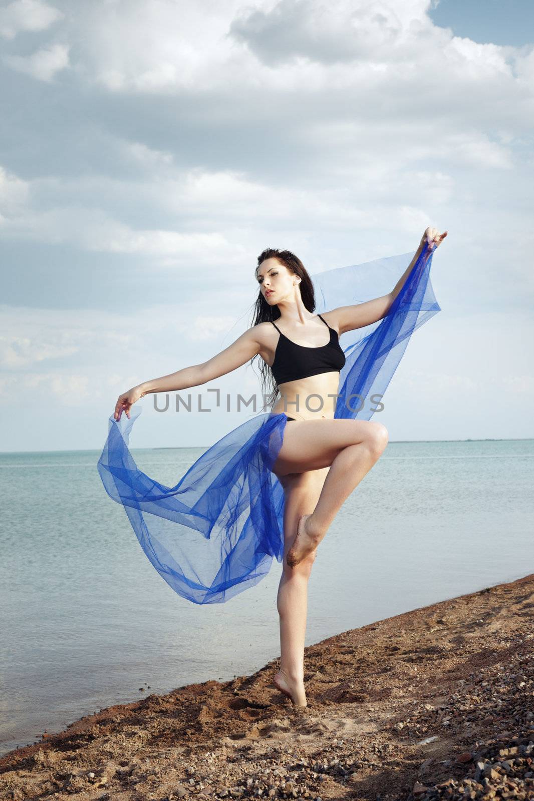 Beautiful lady dancing at the beach