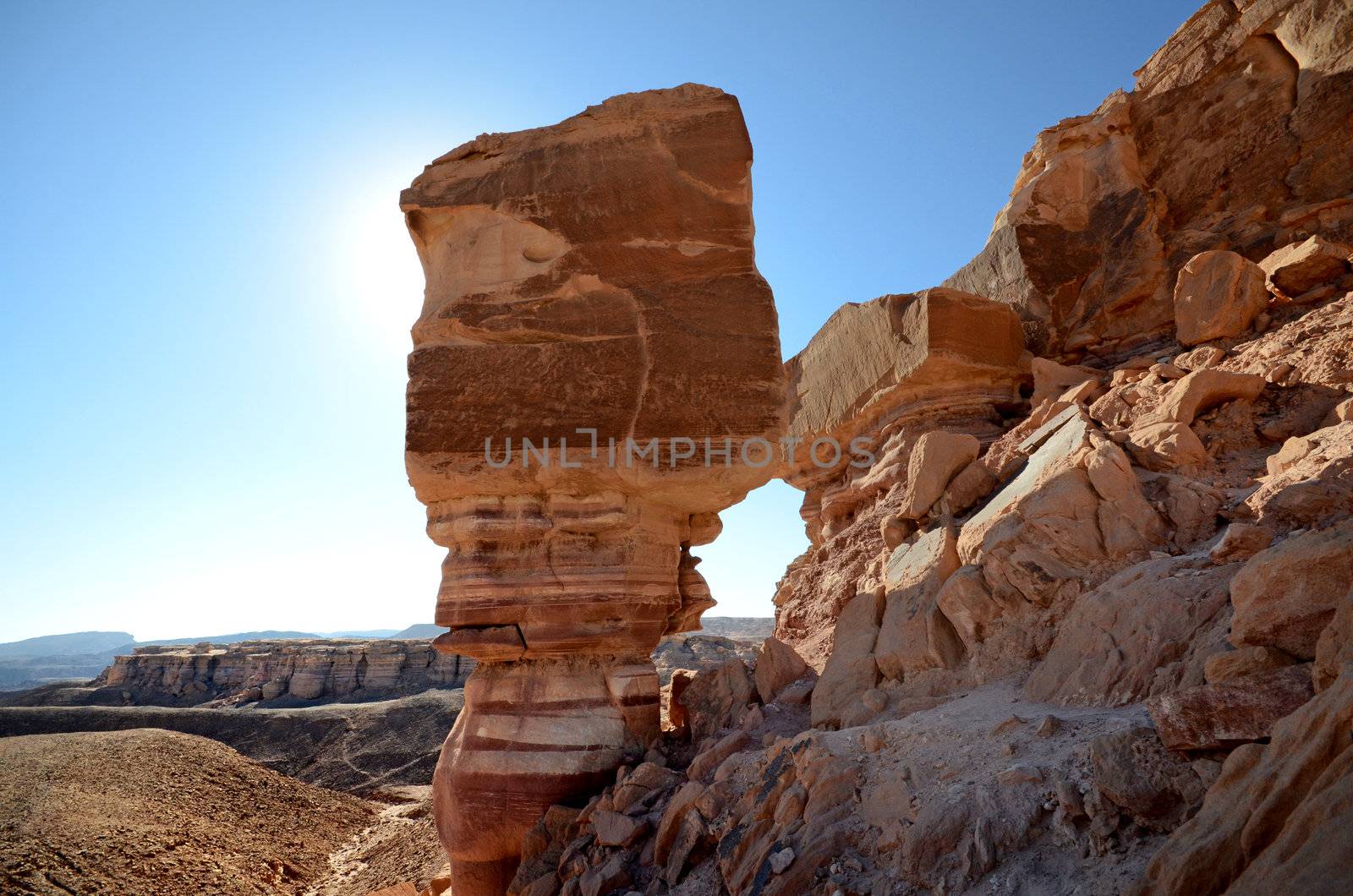 desert landscape under bright blue sky and sun