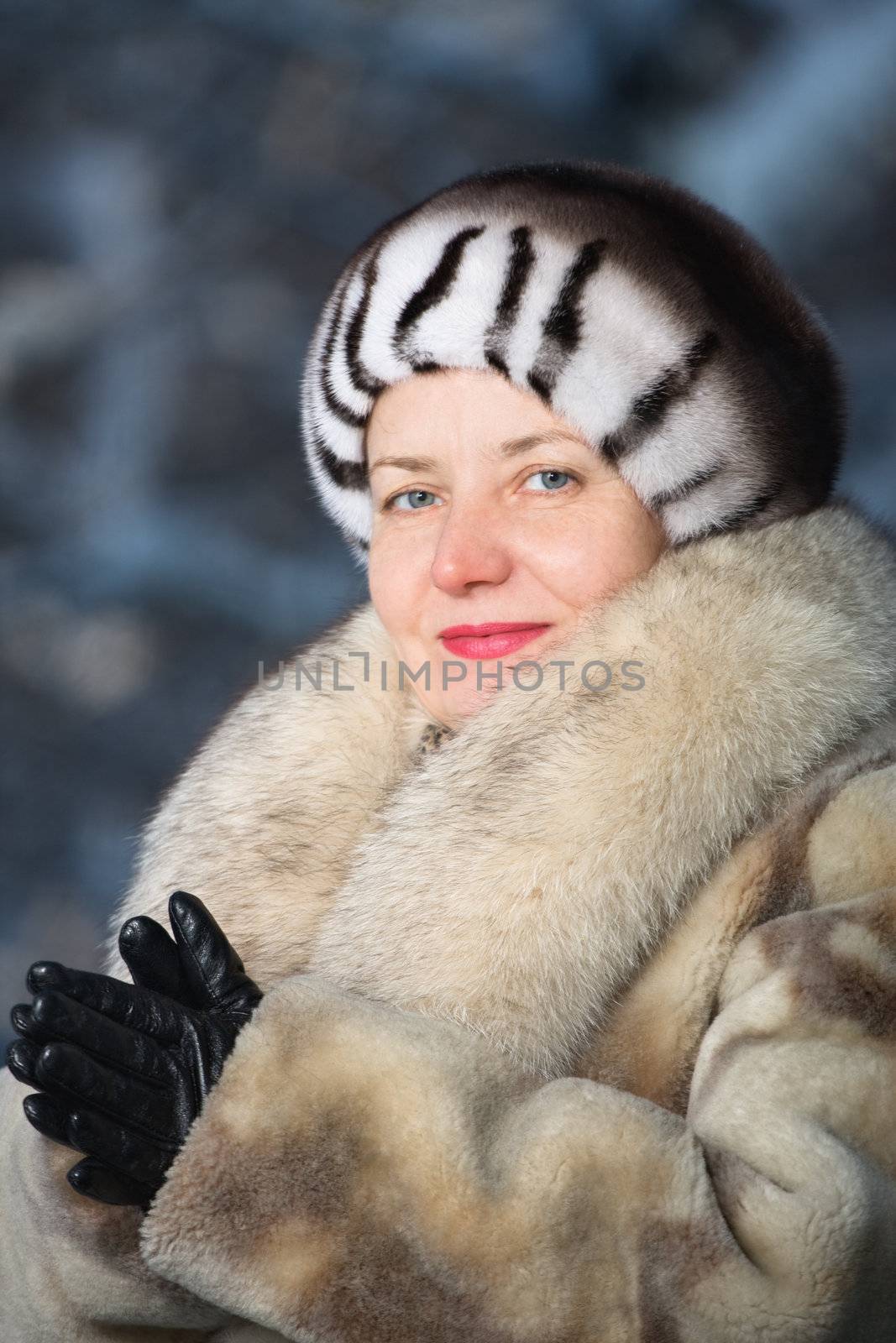 The woman of average years in a winter fur coat