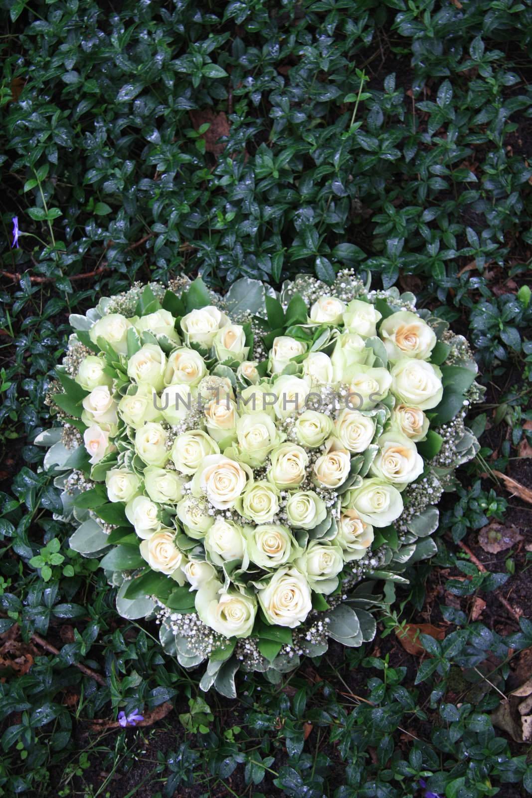 Heart shaped sympathy flower arrangement with white roses