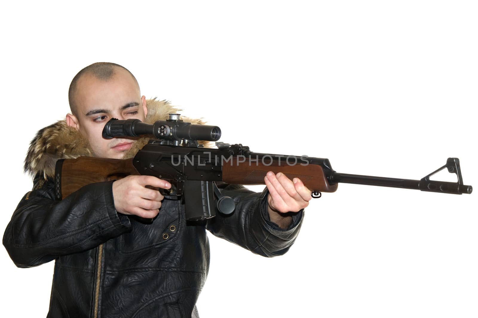 Young the man aims from a carbine with an optical sight