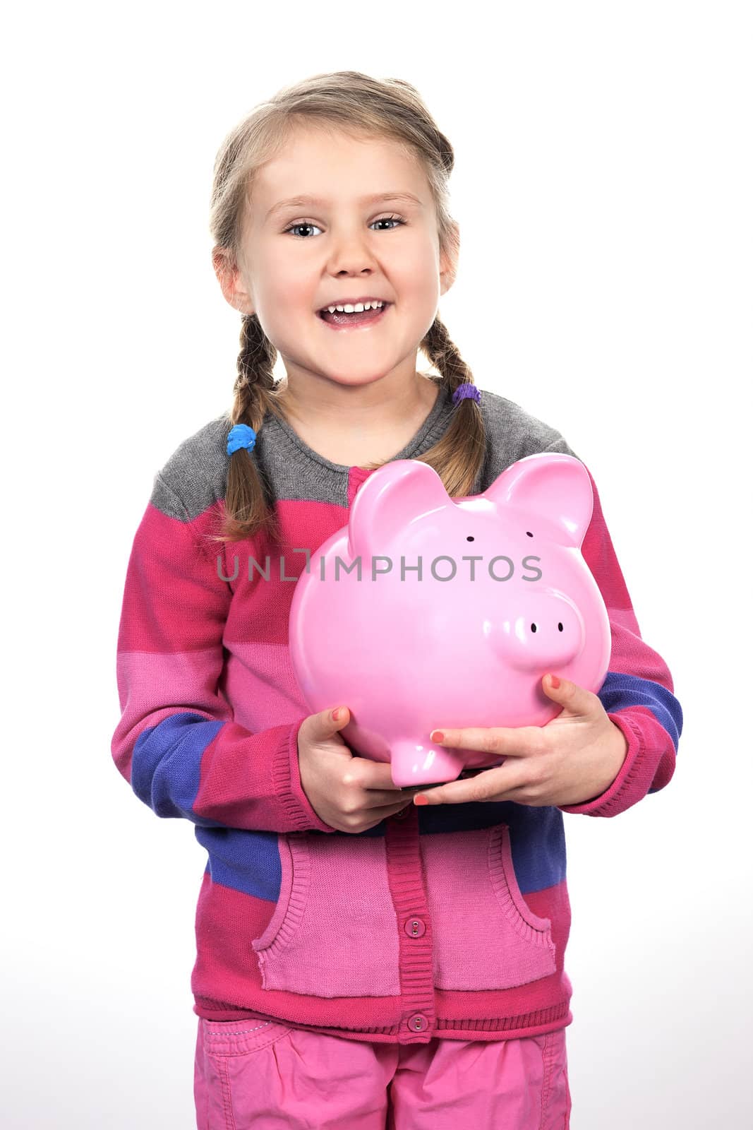 girl shaking a piggy bank 