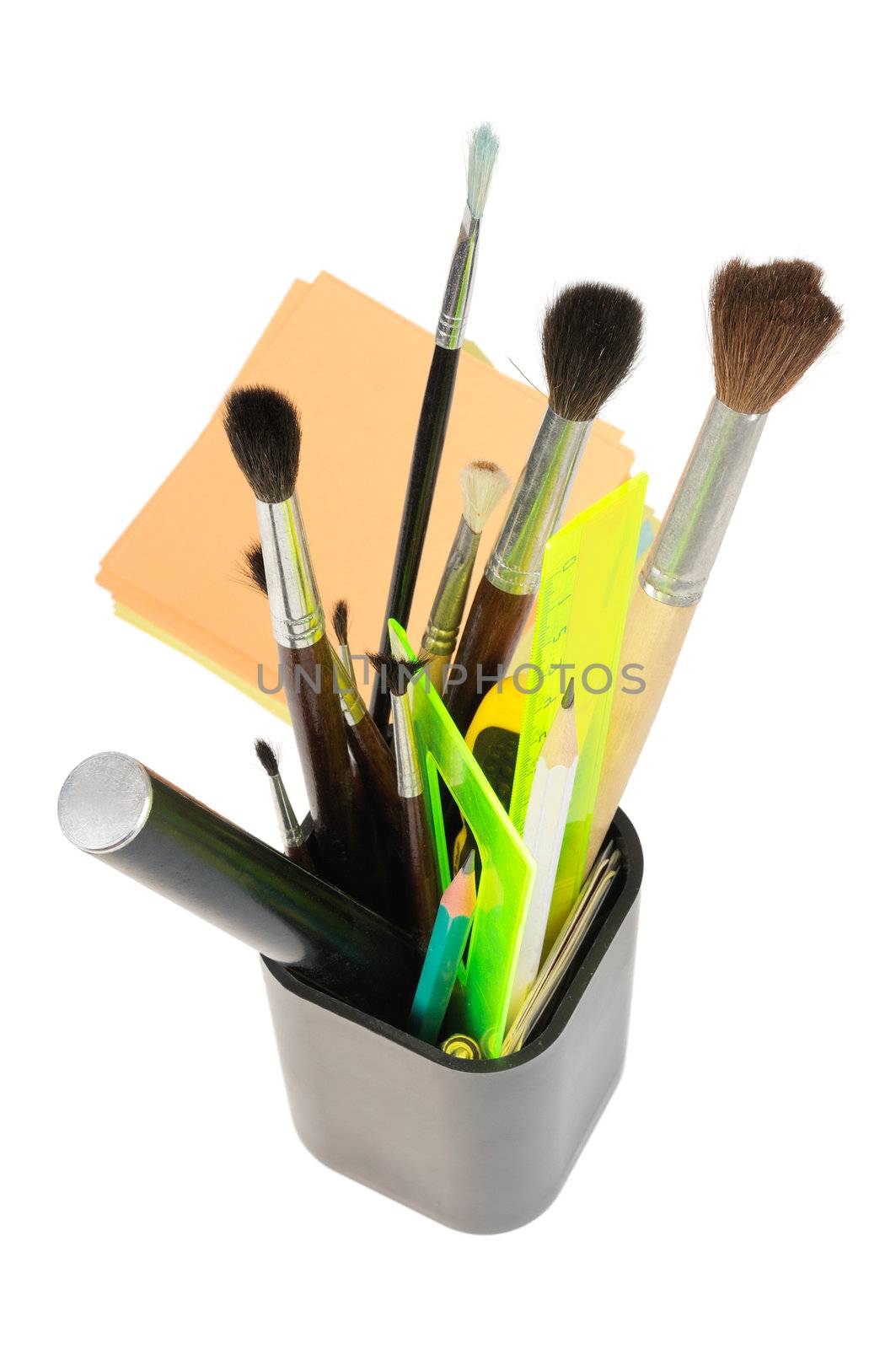 A box with stationery, pens, brushes, rulers. Isolated on white.