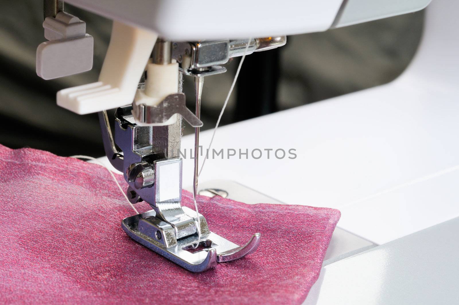 Sewing machine close up with a cloth.