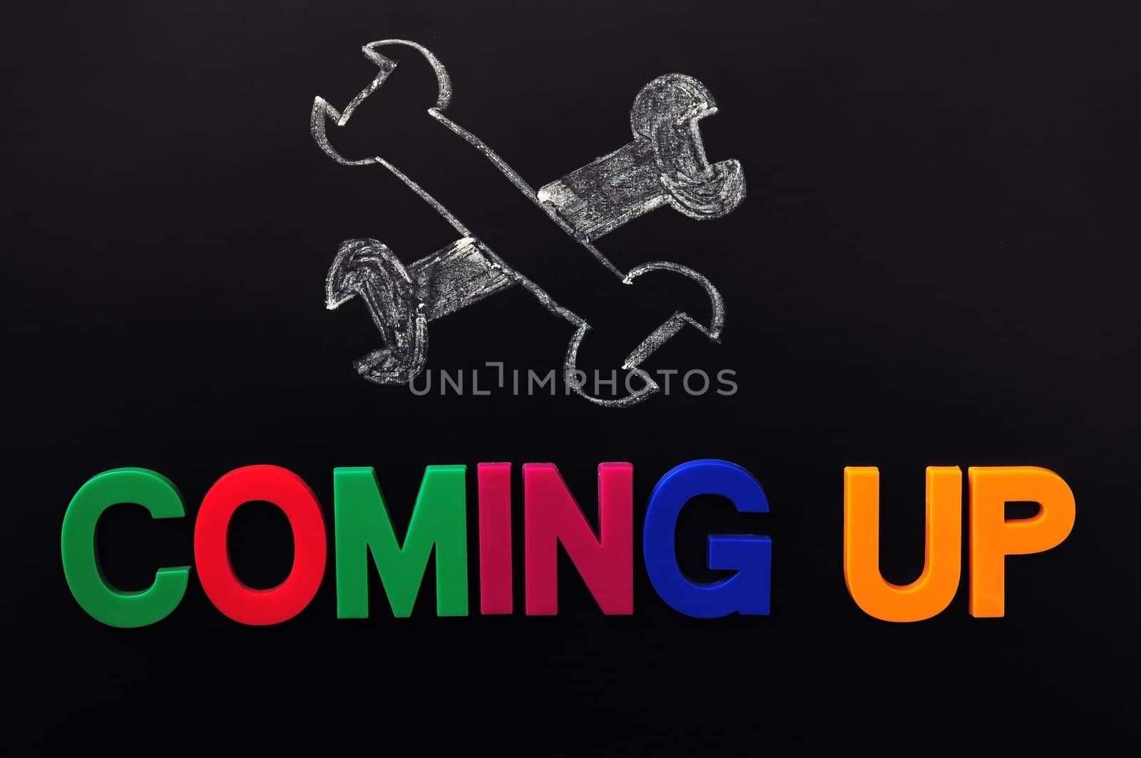 Under construction and coming up concept on a blackboard