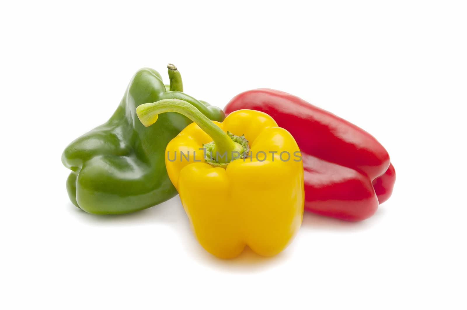 yellow pepper, red and green on white background