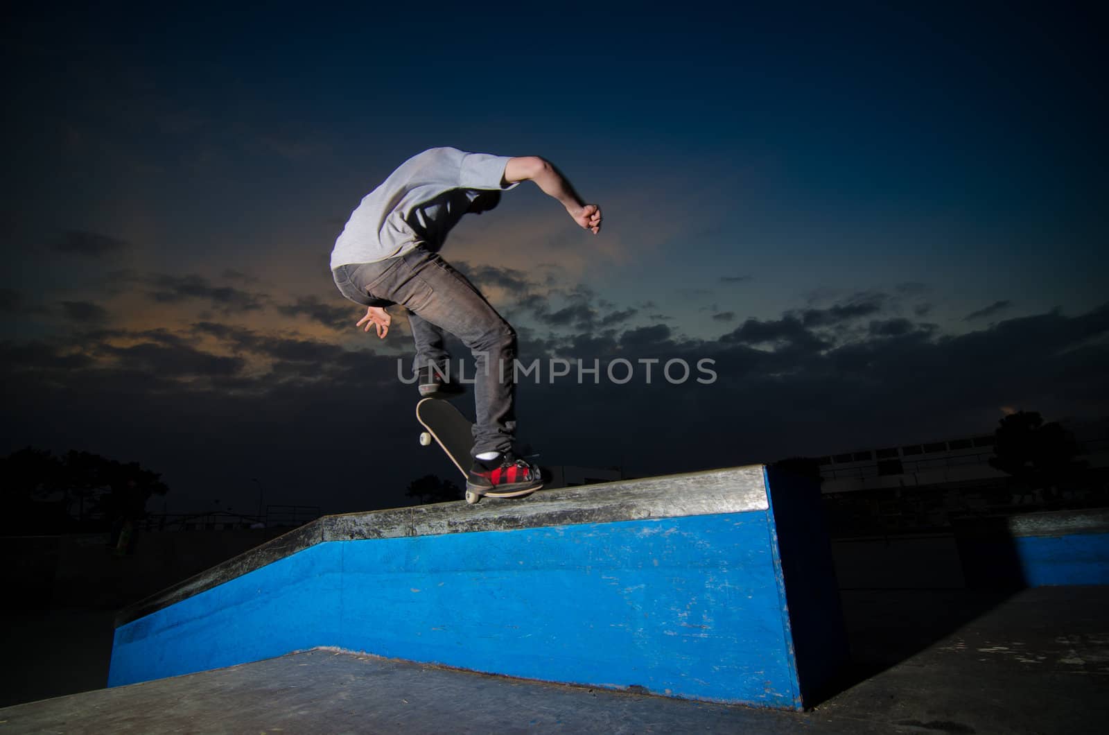 Skateboarder on a grind at the local skatepark.