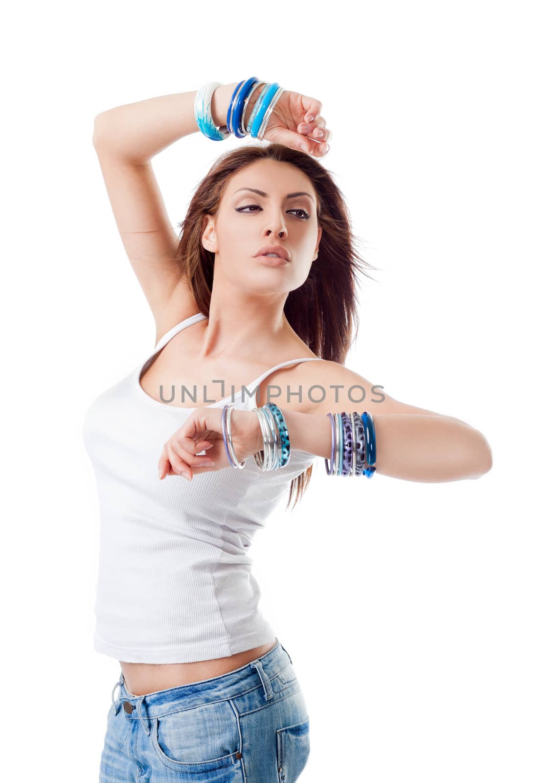 Beautiful young woman with bracelets raising her arms, dancing on white background