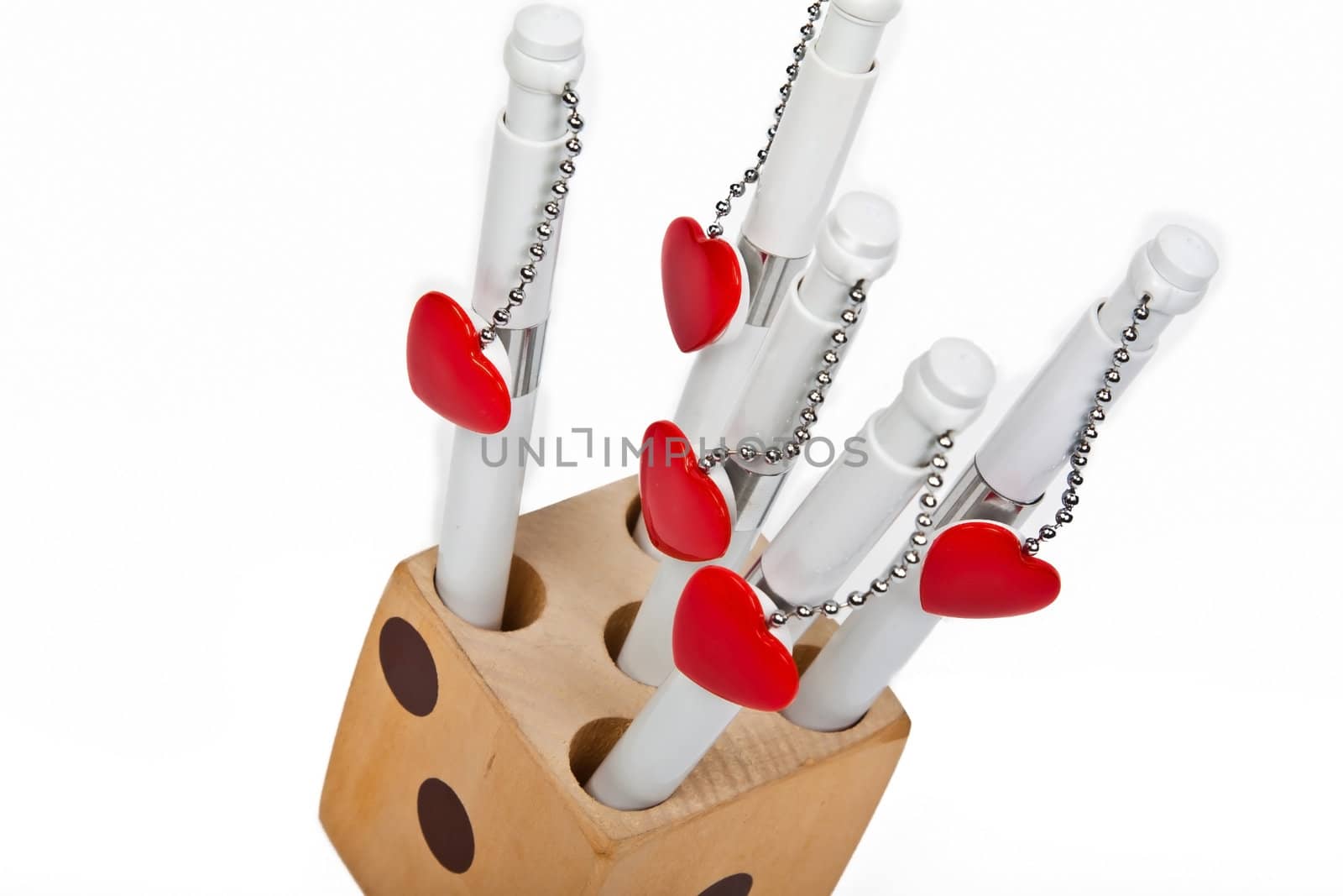 five red hearts wait in wooden box