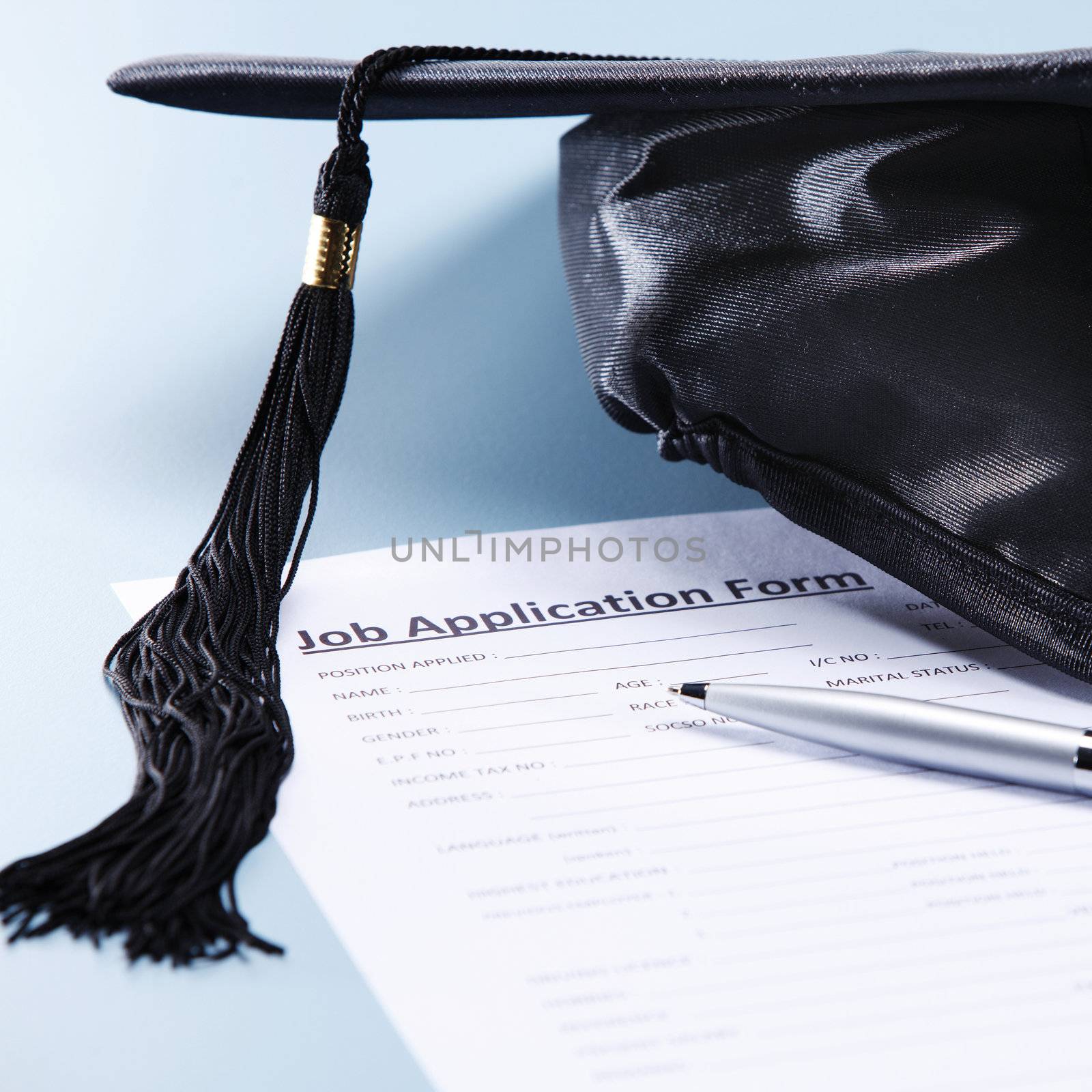 stock image of the mortar board and job application form