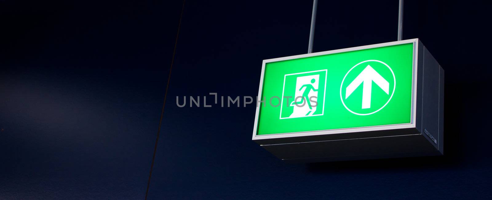 Emergency exit sign in modern offices inside an industrial plant