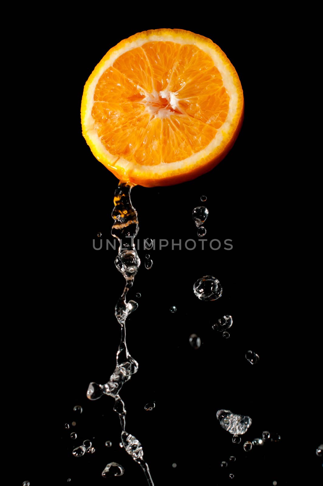 Fresh and bright orange part and waterdrops flying