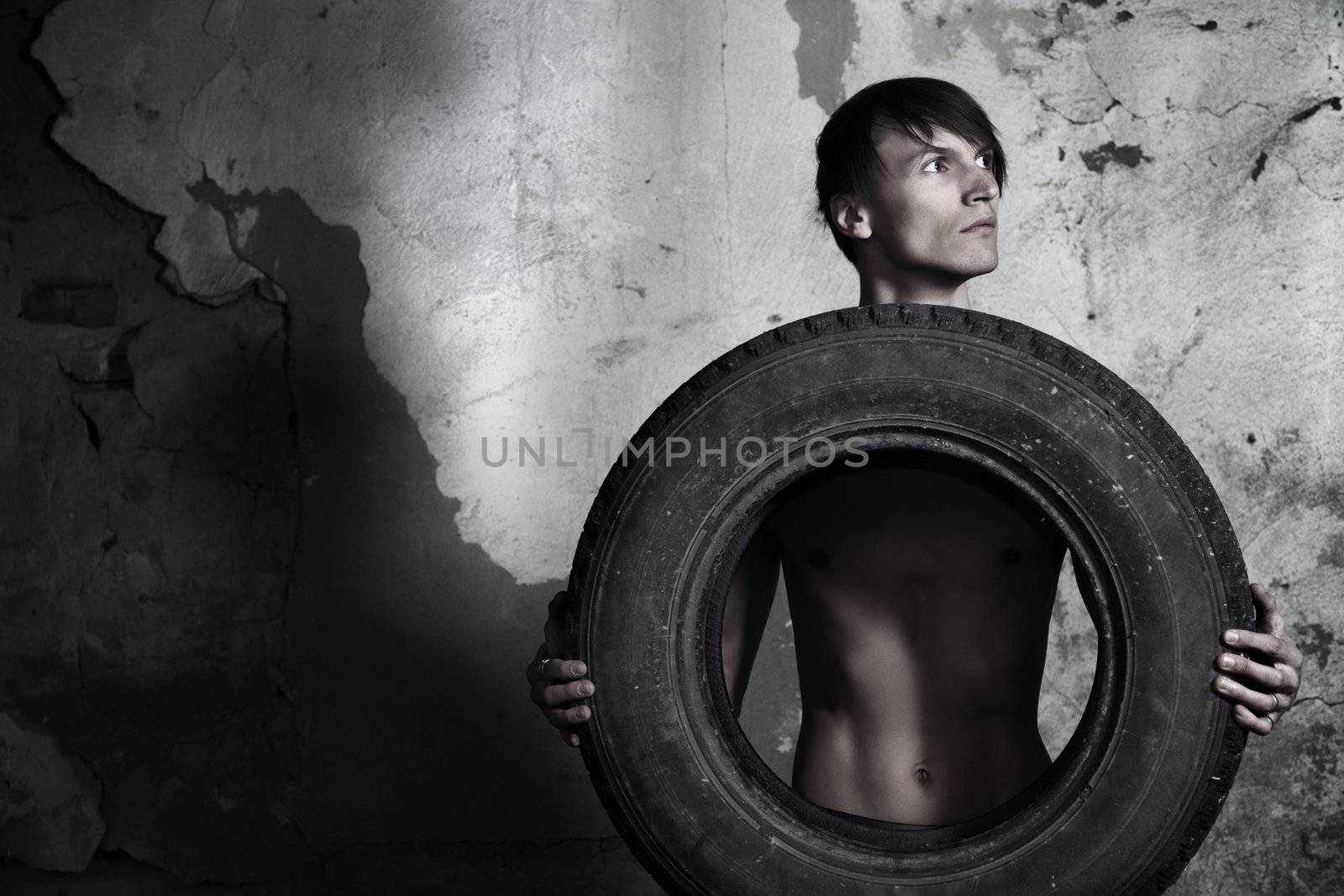 Man holding automobile tire