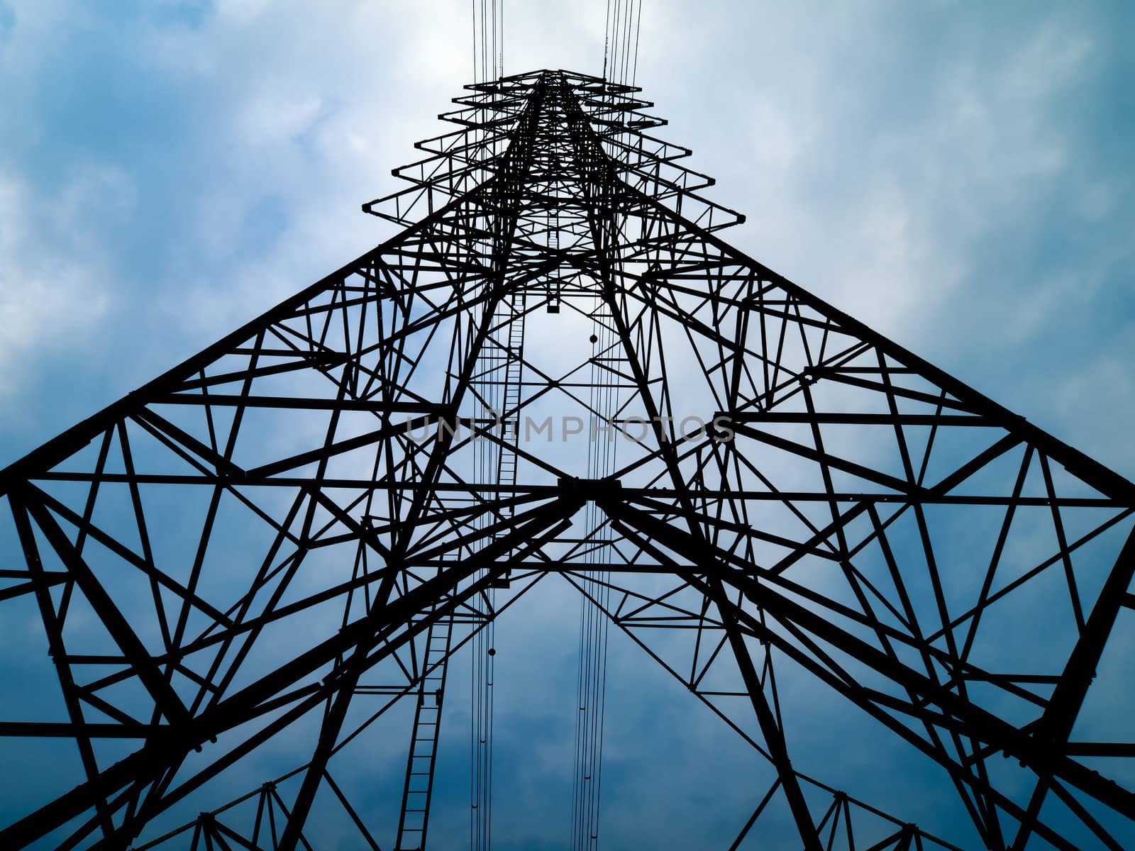 Silhouette Front view of high voltage tower and overcast sky