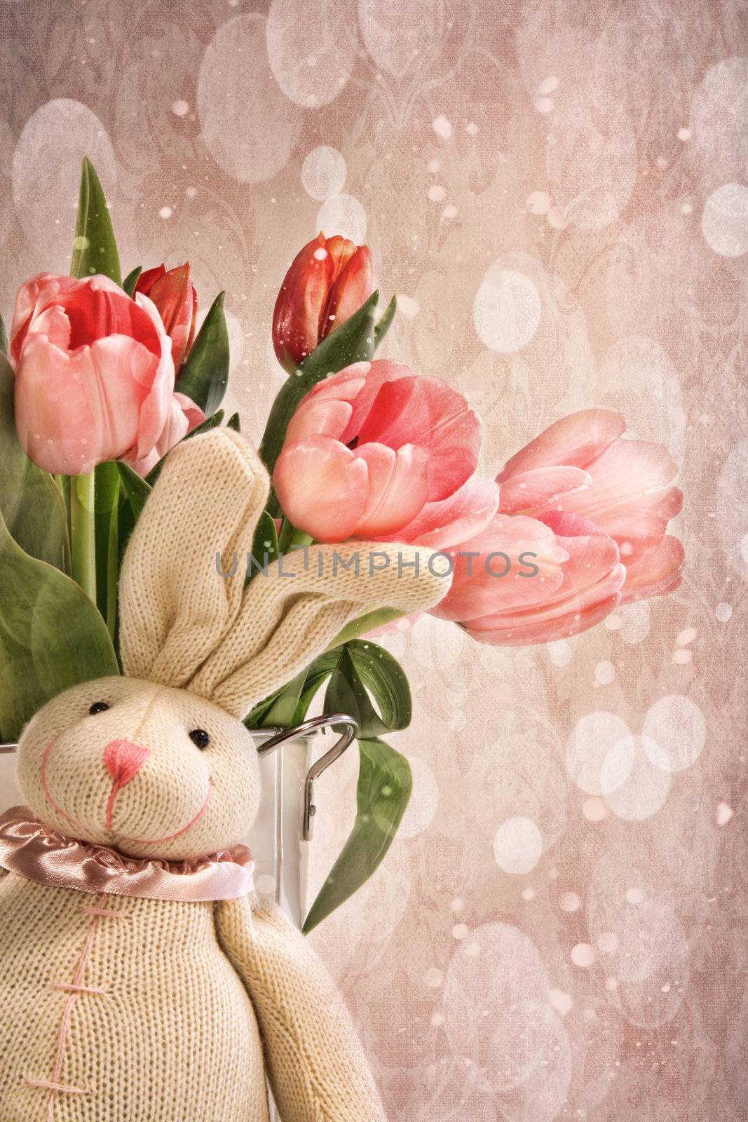Toy rabbit with pink tulips for easter