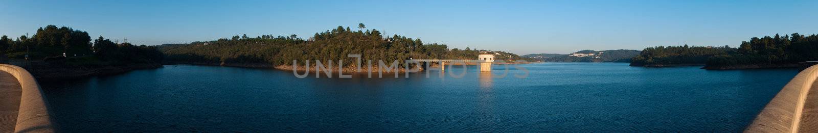 stunning view of river Zezere and Castelo de Bode Dam in Tomar, Portugal (panoramic picture with gorgeous blue sky)