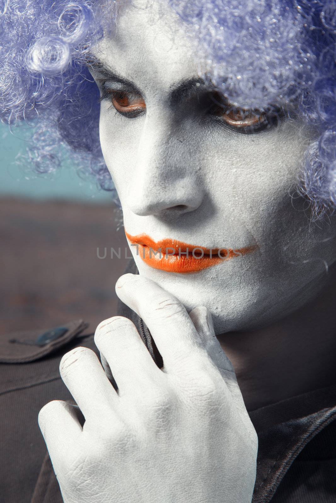 Single sad funny man with theatrical makeup and wig