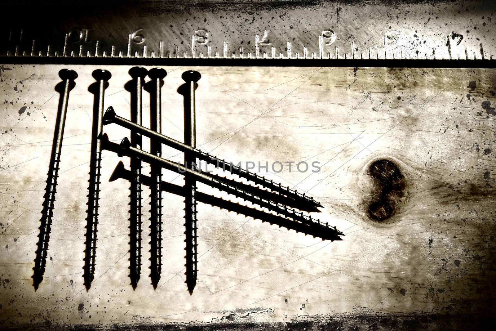 Screws and ruler on a grunge background