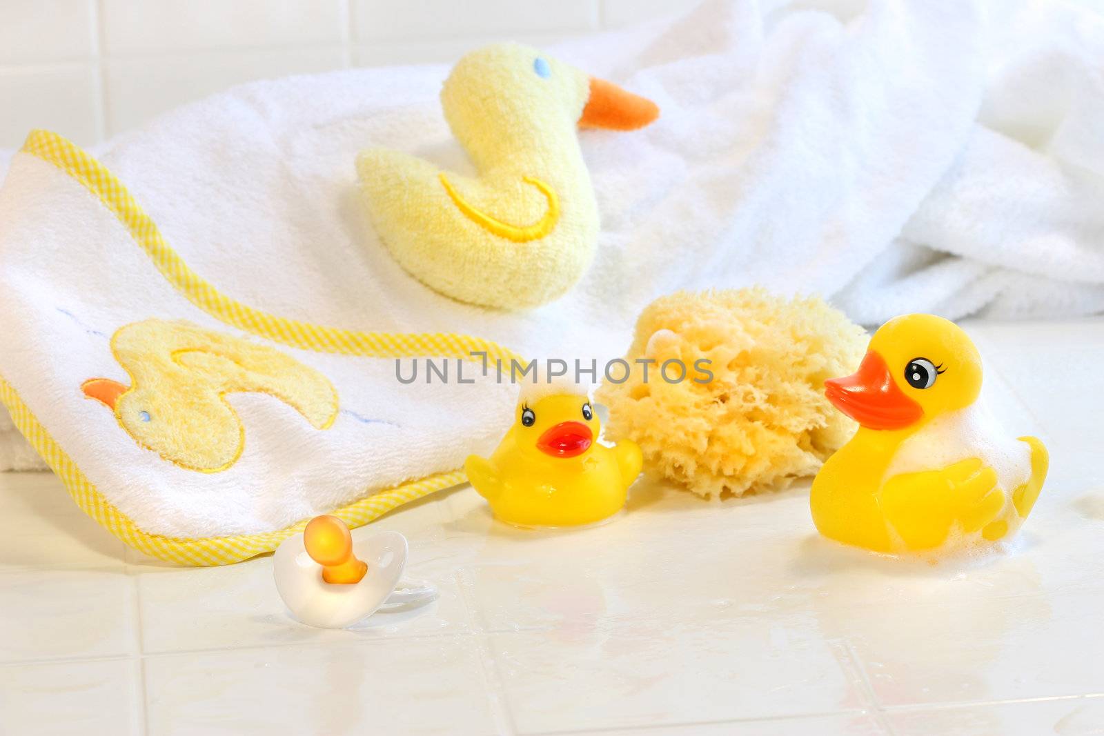 Bathtime for baby with toys and towel 