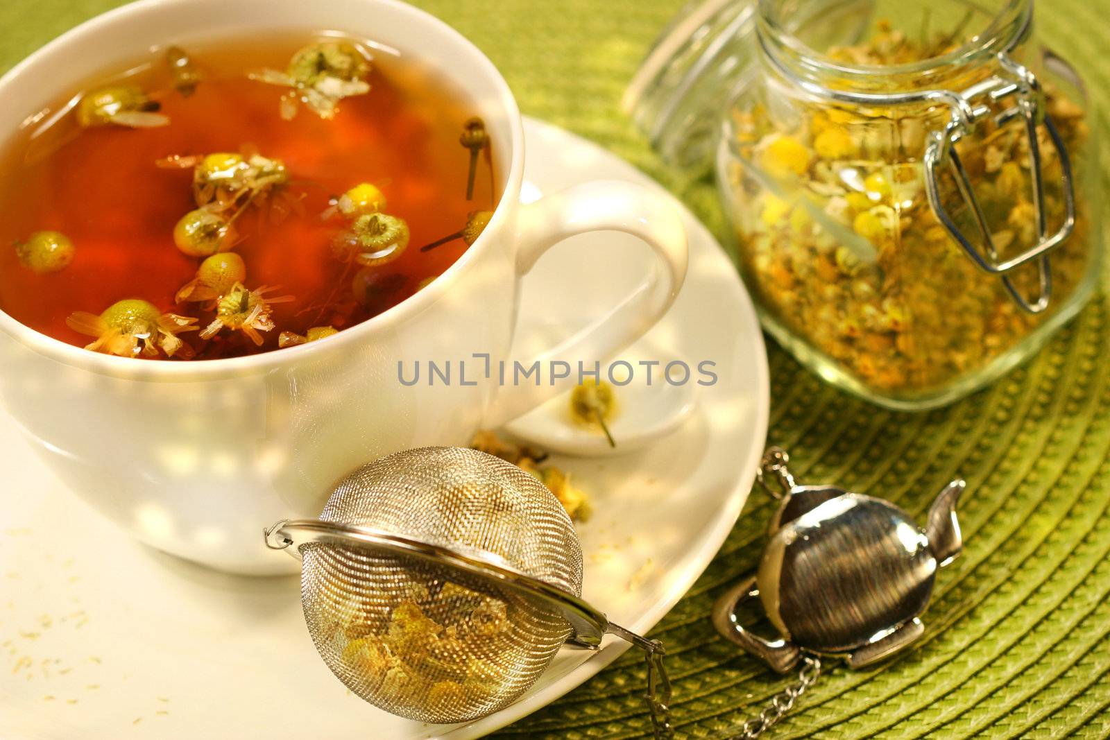 Chamomile  tea with white tea cup on green place mat